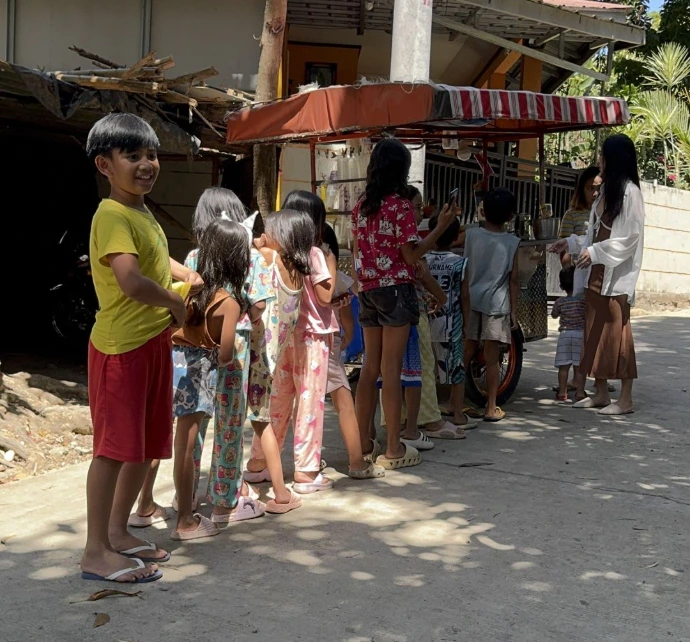 Children receiving free meals during community outreach program