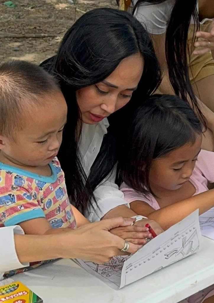 YBO Director helping children with learning activity