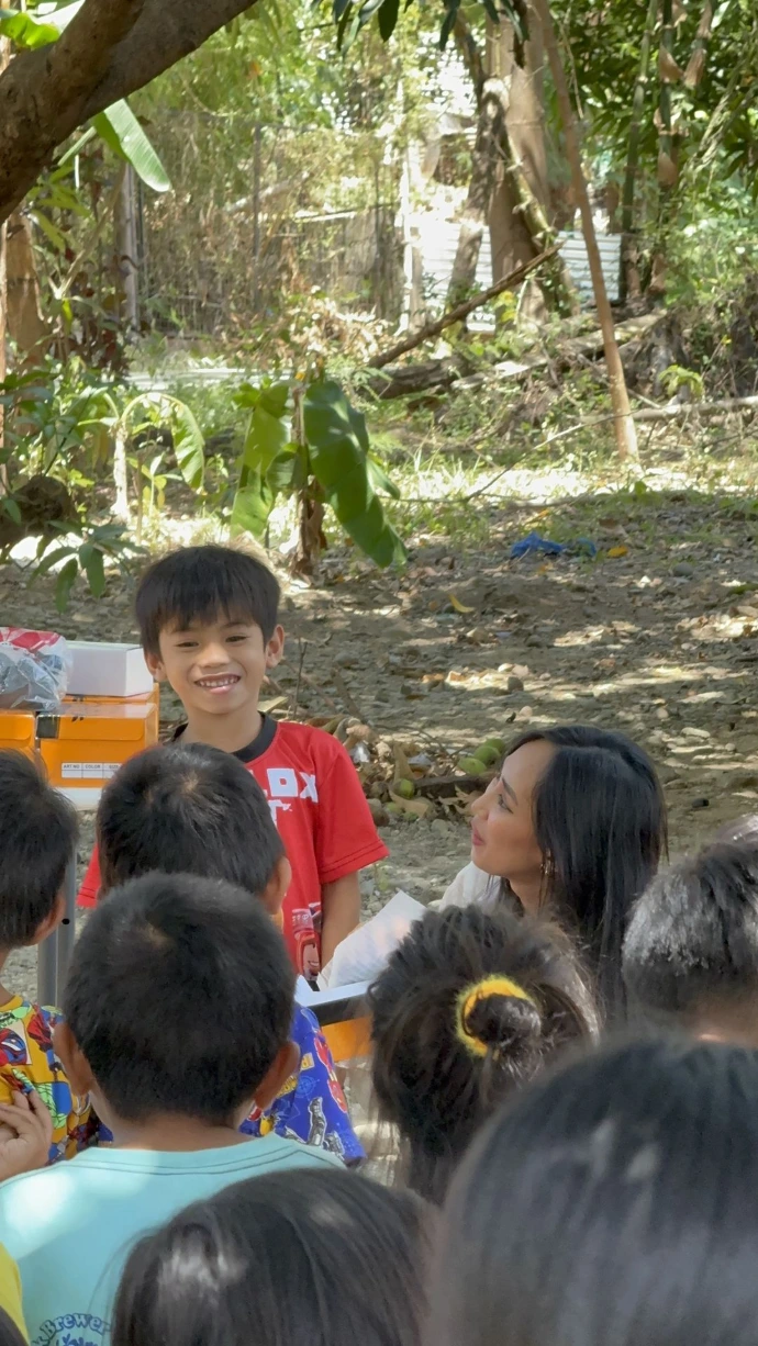 Children receiving graduation shoes from donation program